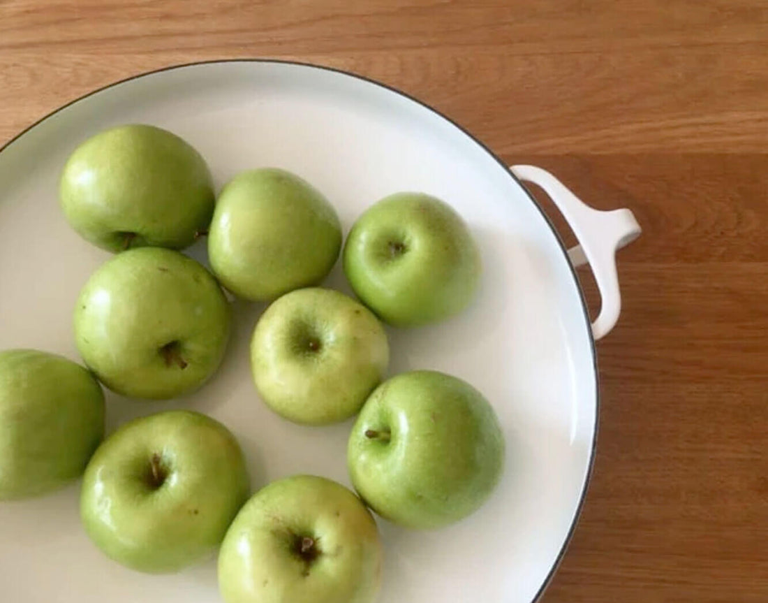 Green apples on a white plate