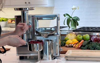 Pressing beets in the PURE Juicer in a home kitchen