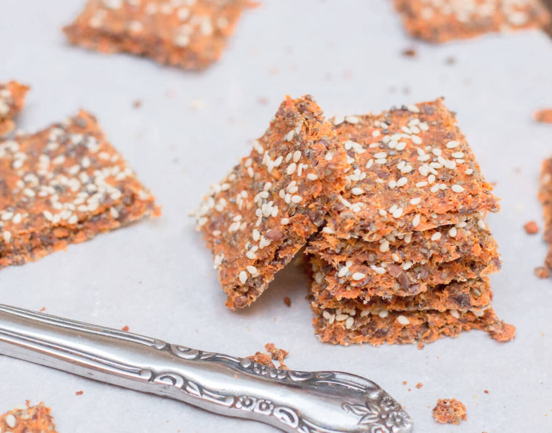 Stacked carrot juice pulp crackers sprinkled with seeds