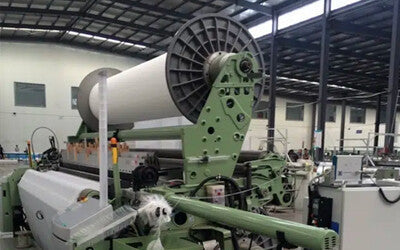 Press cloth being woven in a textile mill