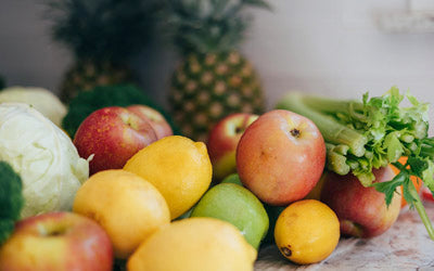 A spread of fresh fruits and vegetables for juicing