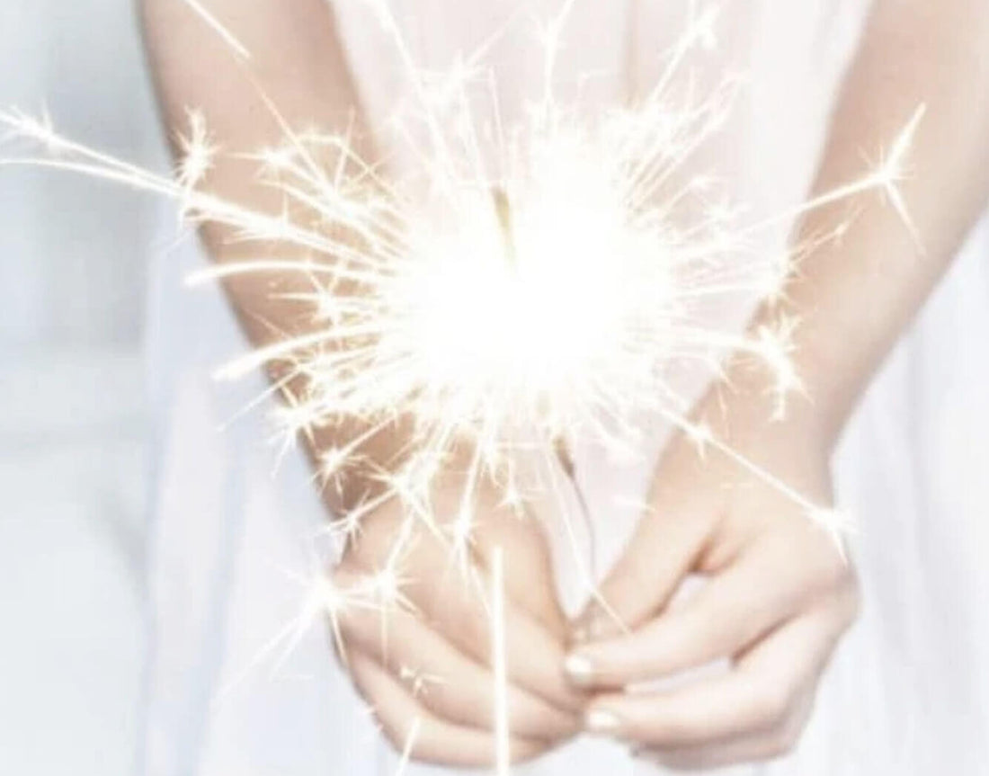 Hands holding a lit sparkler