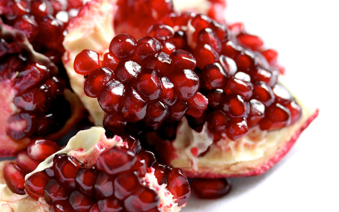 A cut pomegranate with bright red seeds