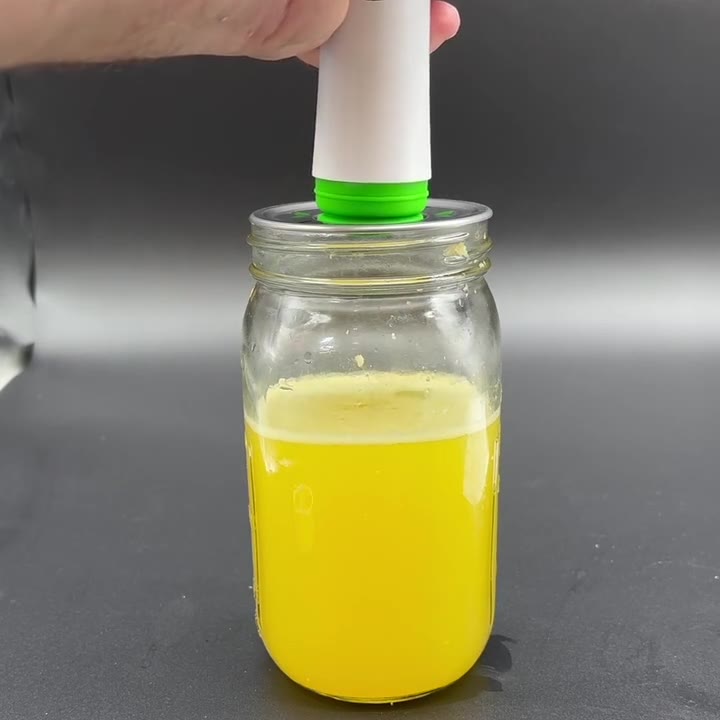 Hand pulling the MVP pump upward on a jar